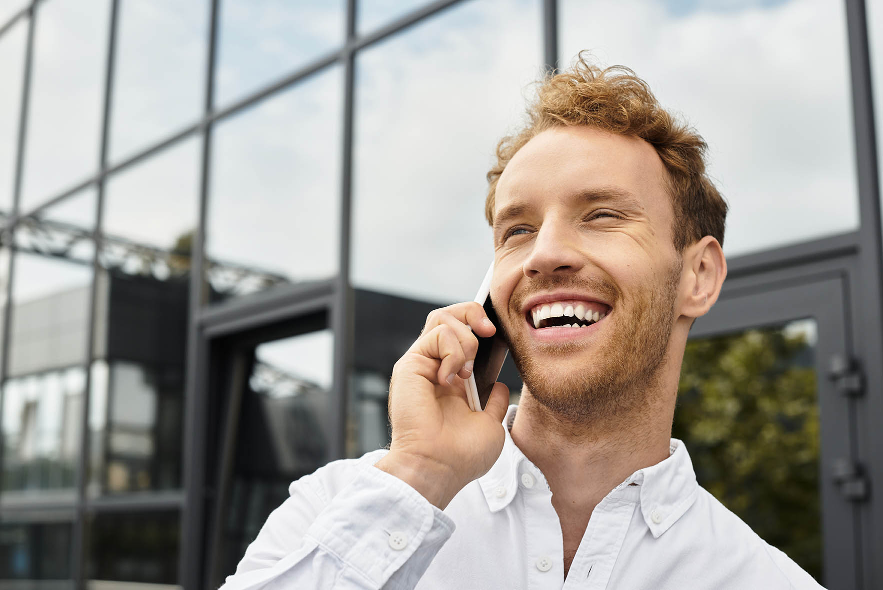 A cheerful businessman with red hair discusses a project on his